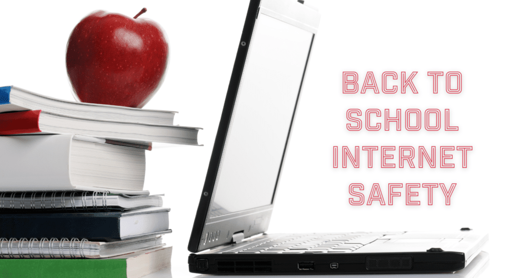 Image of a laptop next to a stack of books with a red apple on top.