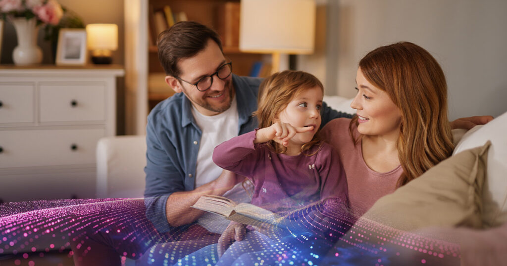 A young couple with their daughter, reading a book together.