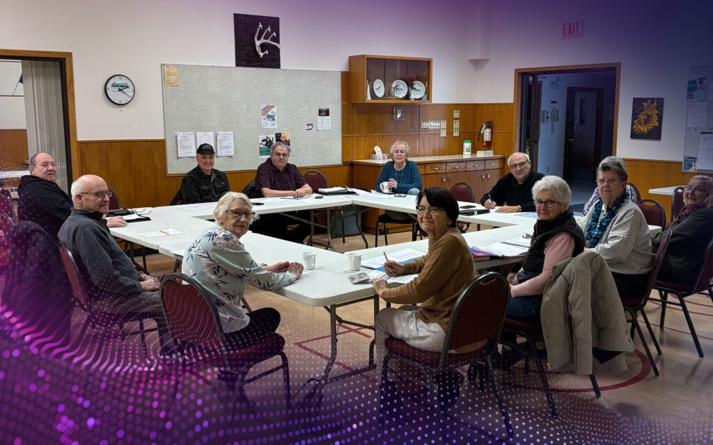 The dedicated board members at the Pioneer Circle Seniors Centre sitting around a table,