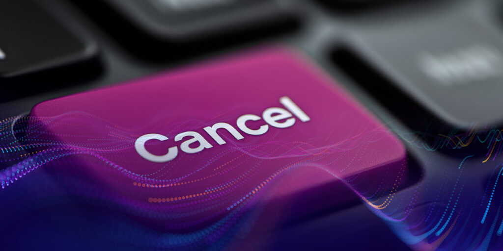 A close-up view of a "cancel" button on a keyboard, highlighted in purple.