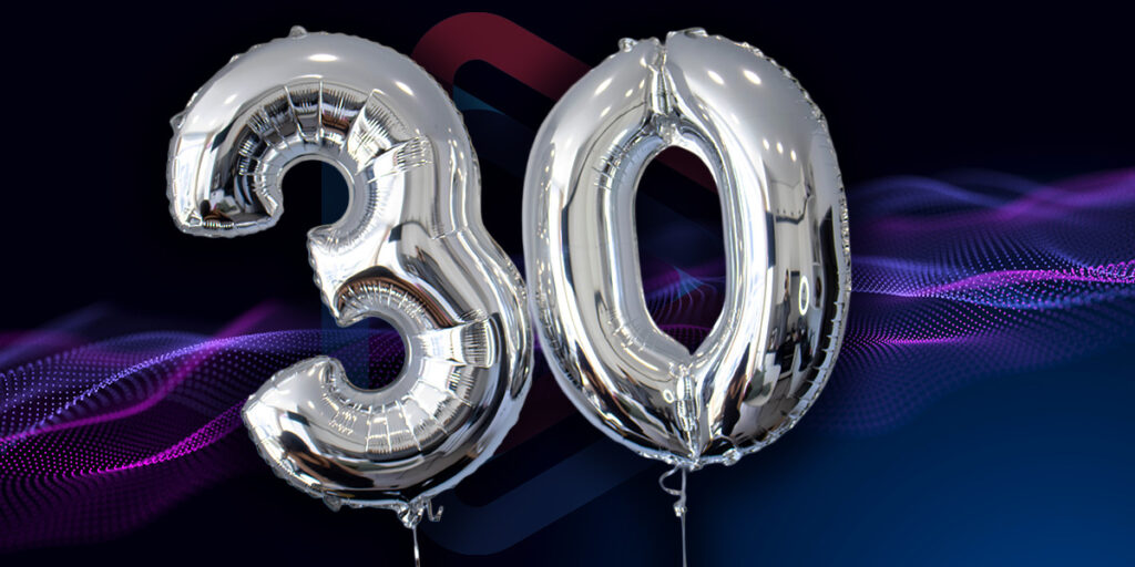 Image of two silver balloons spelling "30" on a dark background.