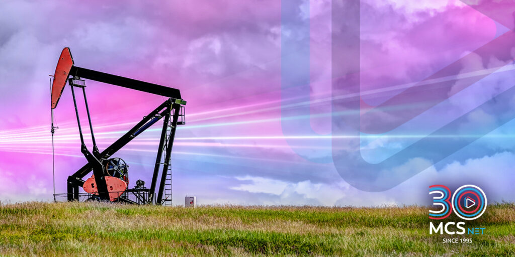 Image of a pump jack oil well with MCSnet's icon in the background and a digital wave.