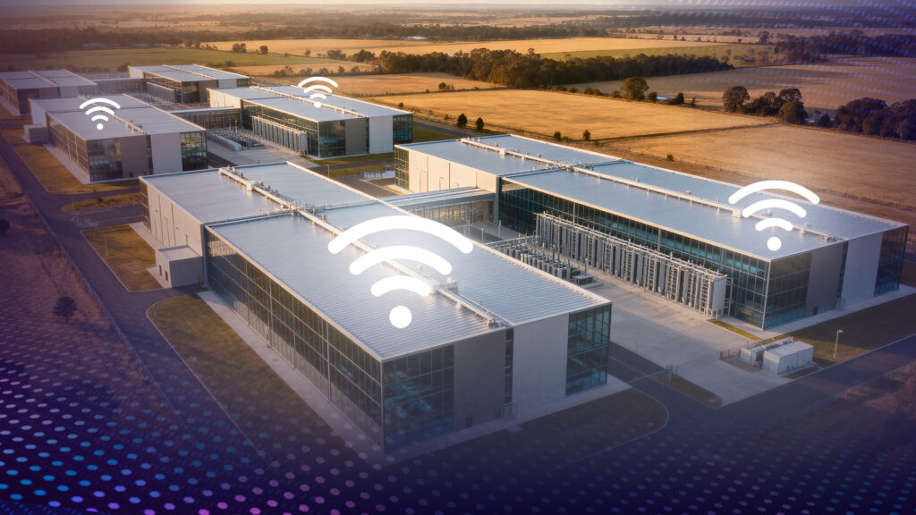 Top down view of a series of warehouse-style buildings with digital wi-fi signals above them.