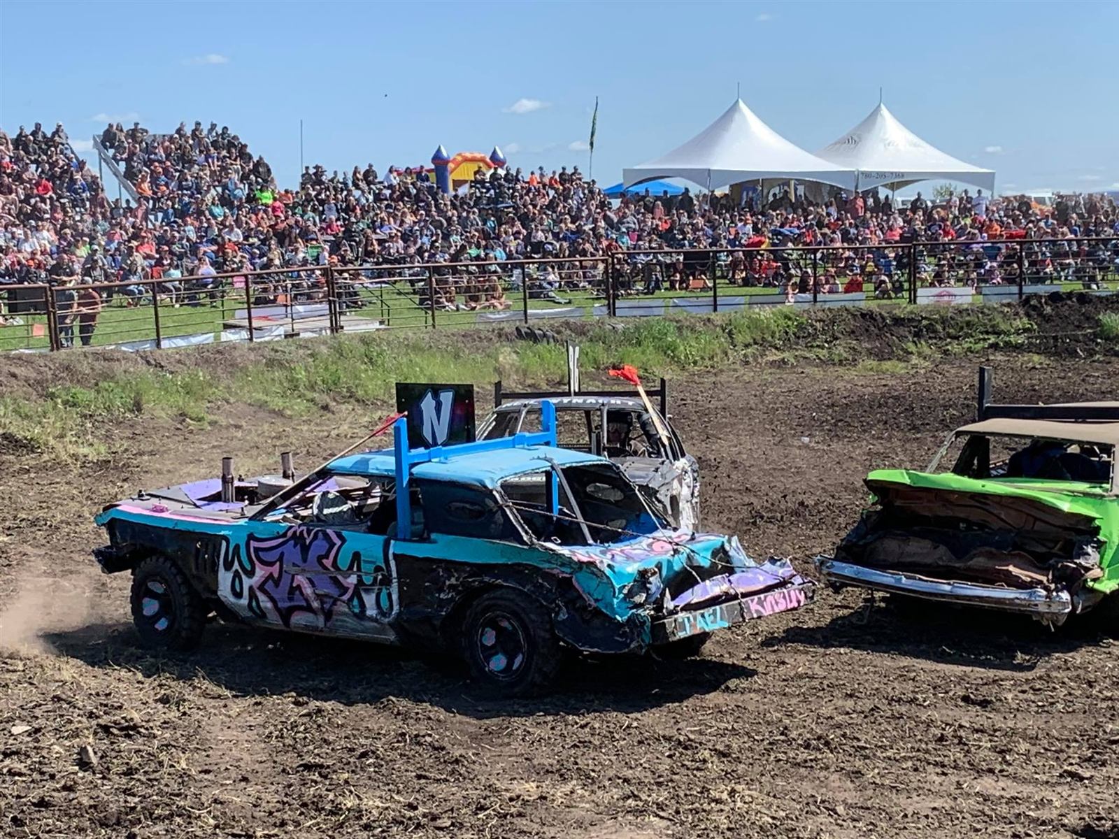 Crowd and cars at the Glendon Derby and Mud Bogs event in Glendon, Alberta